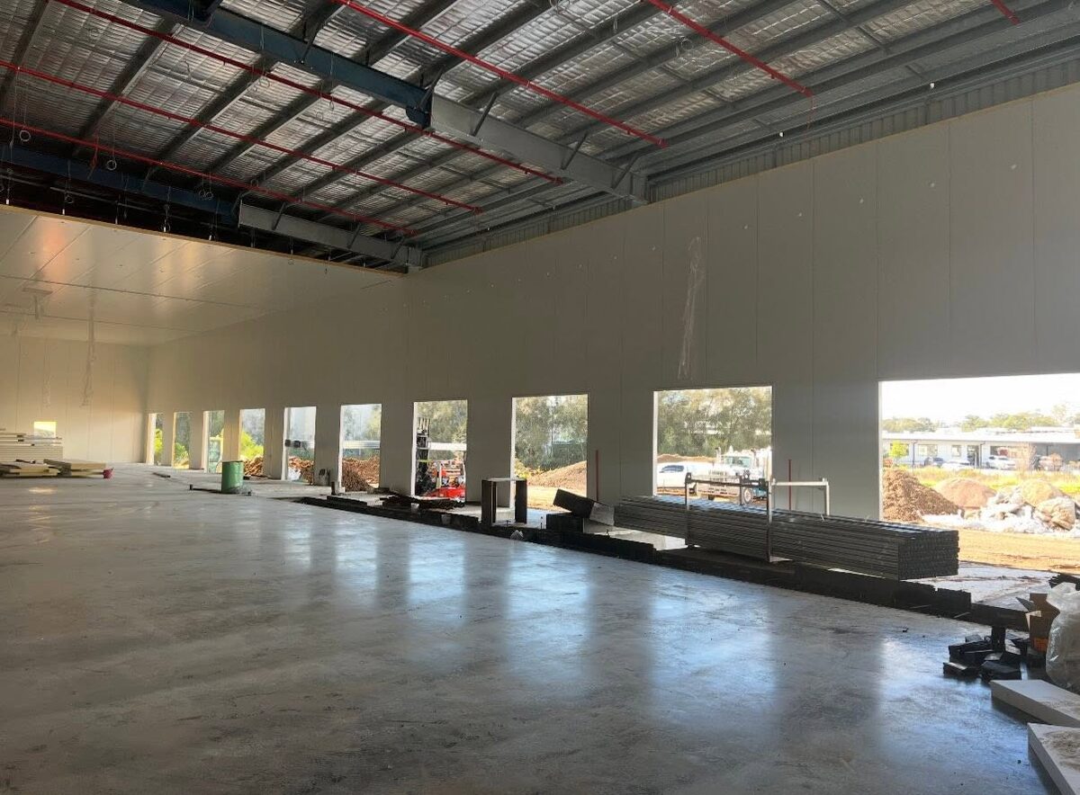 Insulated panels being lifted into place on a commercial coolroom build in progress