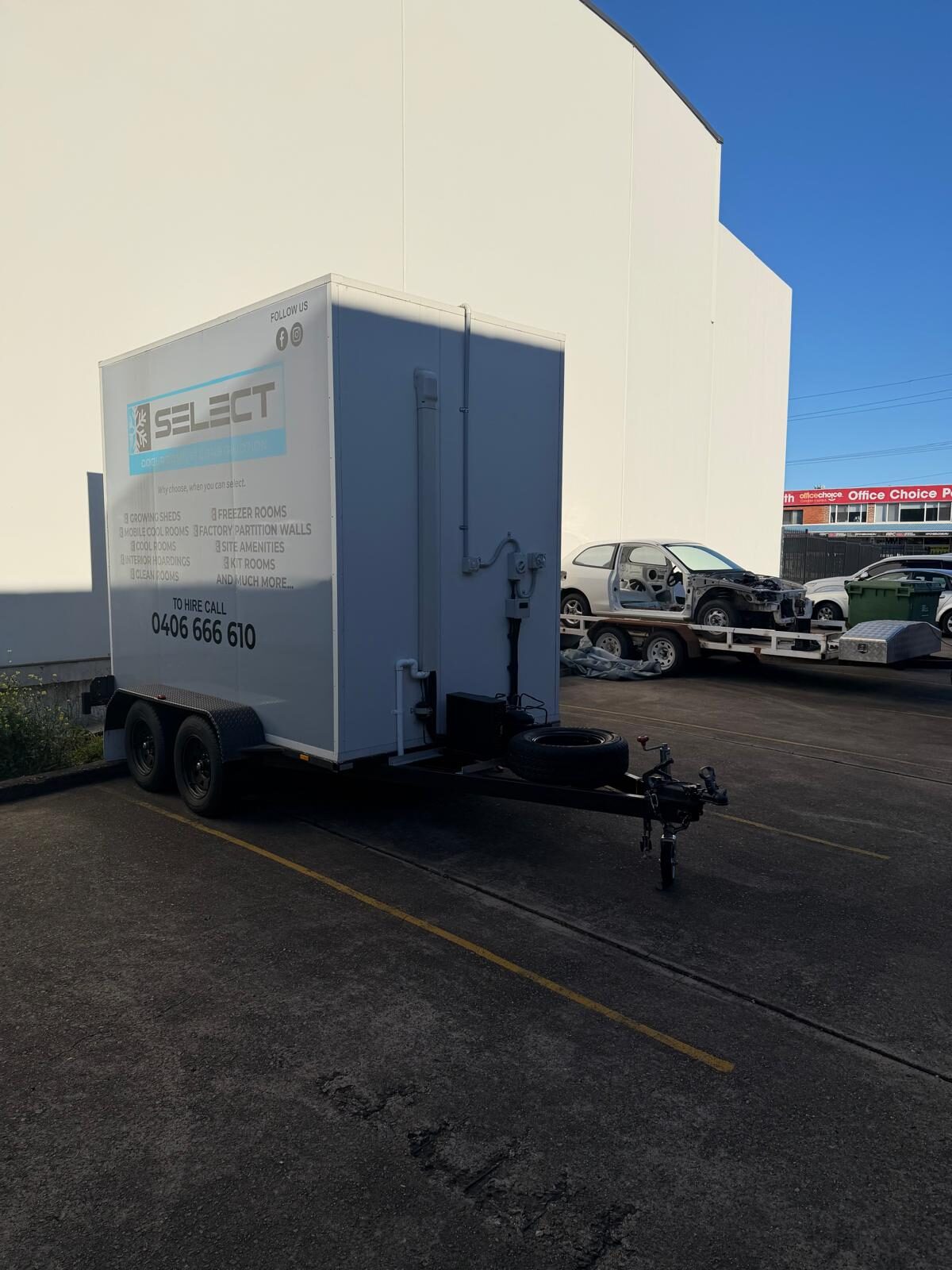 The rear of the hire trailer, showing the back panel and the tandem-axle running gear